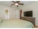 Spacious bedroom featuring wood floors, a ceiling fan, and access to a bathroom at 4021 Vana Dr, Sarasota, FL 34241