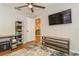 Bedroom featuring mounted television, ceiling fan, and wood-look flooring at 4021 Vana Dr, Sarasota, FL 34241
