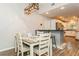 Inviting dining area features modern light fixture, bar seating, and an open-concept kitchen beyond at 4021 Vana Dr, Sarasota, FL 34241