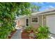 Inviting entrance featuring a screen door, window box, and lush foliage at 4021 Vana Dr, Sarasota, FL 34241