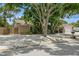 Charming single-story home featuring a gravel yard, mature trees, and detached garage at 4021 Vana Dr, Sarasota, FL 34241