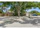 Charming single-story home featuring a gravel yard, mature trees, and detached garage at 4021 Vana Dr, Sarasota, FL 34241