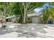 Cozy home with concrete driveway, single car garage, and lush landscaping at 4021 Vana Dr, Sarasota, FL 34241