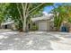 Cozy home with concrete driveway, single car garage, and lush landscaping at 4021 Vana Dr, Sarasota, FL 34241