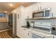 Kitchen featuring stainless steel refrigerator, subway tile backsplash, and granite countertops at 4021 Vana Dr, Sarasota, FL 34241