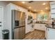 Kitchen features white cabinets, stainless steel appliances, and subway tile backsplash at 4021 Vana Dr, Sarasota, FL 34241