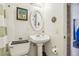 Traditional-style bathroom with a pedestal sink, oval mirror, and shower with green and white striped curtain at 4412 Bray Rd, Tampa, FL 33634