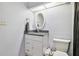Modern bathroom features tiled walls, a granite sink, and oval mirror at 4412 Bray Rd, Tampa, FL 33634