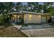 Inviting single-story home featuring a unique roofline, covered entry, and driveway at 4412 Bray Rd, Tampa, FL 33634