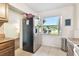 Kitchen with granite counters, stainless steel refrigerator, and modern white appliances at 4412 Bray Rd, Tampa, FL 33634