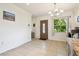 Open-concept living space with tile flooring and a decorative front door at 4412 Bray Rd, Tampa, FL 33634