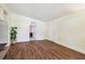 Open-concept living room features wood floors and access to other rooms at 4412 Bray Rd, Tampa, FL 33634
