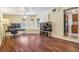 Spacious living room featuring hardwood floors, large windows, and a view into an eat-in kitchen at 4412 Bray Rd, Tampa, FL 33634