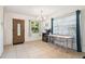 Bright living room featuring tile floors, a chandelier, and a decorative front door at 4412 Bray Rd, Tampa, FL 33634