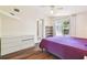 Bright bedroom features hardwood floors and a sliding glass door with curtains at 4412 Bray Rd, Tampa, FL 33634
