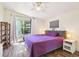 Bright bedroom features hardwood floors, a ceiling fan, and a glass sliding door at 4412 Bray Rd, Tampa, FL 33634