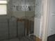 Bathroom with partially framed walls and patterned wallpaper at 4673 Dewey Dr, New Port Richey, FL 34652
