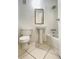 Compact bathroom featuring pedestal sink, updated shower head, and tile flooring at 501 E Bay Dr # 3504, Largo, FL 33770
