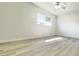 Bright bedroom featuring modern ceiling fan, window with blinds and light, wood-look laminate flooring at 501 E Bay Dr # 3504, Largo, FL 33770
