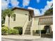 Charming condo featuring well-maintained landscaping, a carport, and an inviting entrance staircase at 501 E Bay Dr # 3504, Largo, FL 33770