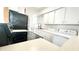 Efficient kitchen featuring white cabinets and modern appliances at 501 E Bay Dr # 3504, Largo, FL 33770