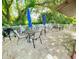 Charming outdoor patio area with tables, chairs, umbrellas, and a grill, perfect for relaxing and entertaining guests at 501 E Bay Dr # 3504, Largo, FL 33770