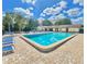 Community pool features lounge seating and a bright blue pool on a sunny day at 501 E Bay Dr # 3504, Largo, FL 33770