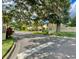 Street view of Magnolia Square Condominiums, showcasing lush landscaping and a welcoming entrance sign at 501 E Bay Dr # 3504, Largo, FL 33770