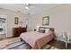 Comfortable bedroom boasts ceiling fan, vibrant rug, full bed, art, and easy access to the laundry area at 502 Lincoln Ave, Tarpon Springs, FL 34689