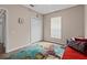 Neutral bedroom featuring a colorful accent rug, closet, and a bright window at 502 Lincoln Ave, Tarpon Springs, FL 34689