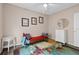 Bedroom features a comfortable daybed, cheerful wall art, and a classic white dresser at 502 Lincoln Ave, Tarpon Springs, FL 34689