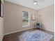Bright bedroom with hanging chandelier, polished concrete floors, neutral paint, and a window with neighborhood views at 502 Lincoln Ave, Tarpon Springs, FL 34689