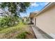 Exterior side view of the home with well-kept lawn and landscaped garden at 502 Lincoln Ave, Tarpon Springs, FL 34689