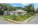 Quaint bungalow with well-manicured landscaping and charming front porch at 502 Lincoln Ave, Tarpon Springs, FL 34689