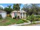 Inviting bungalow with a landscaped yard, charming columns and shuttered windows at 502 Lincoln Ave, Tarpon Springs, FL 34689