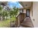 Charming front porch with wood railing, and view of the landscaped front yard at 502 Lincoln Ave, Tarpon Springs, FL 34689