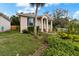Charming home with a well-manicured front yard featuring lush greenery and colorful plants at 502 Lincoln Ave, Tarpon Springs, FL 34689