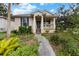 Charming single-story home with a covered porch and lush landscaping at 502 Lincoln Ave, Tarpon Springs, FL 34689