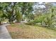 Well-maintained front yard with lush landscaping and mature trees, enhancing curb appeal at 502 Lincoln Ave, Tarpon Springs, FL 34689