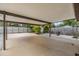 A covered patio with pea rock, chairs and a gate to access the street at 507 4Th Sw Ave, Largo, FL 33770