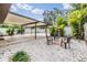 Covered patio with outdoor seating, pea rock, and a fenced yard at 507 4Th Sw Ave, Largo, FL 33770
