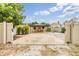 Gated home with a large driveway and an attached carport at 507 4Th Sw Ave, Largo, FL 33770