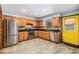 Bright kitchen with stainless steel appliances, light wood cabinets, and colorful backsplash at 507 4Th Sw Ave, Largo, FL 33770