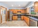 Well lit kitchen features stainless steel appliances, tile backsplash, and granite counters at 507 4Th Sw Ave, Largo, FL 33770