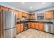 Well-lit kitchen featuring stainless steel appliances, light wood cabinets, and unique backsplash at 507 4Th Sw Ave, Largo, FL 33770