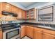Kitchen showcasing light wood cabinets, granite counters, and unique backsplash at 507 4Th Sw Ave, Largo, FL 33770