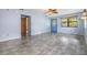 Open living room with tile floors, light blue walls, and a view of the front door and additional rooms at 507 4Th Sw Ave, Largo, FL 33770