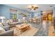 Cozy living room featuring modern furniture, stylish decor, tile flooring and seamless flow into dining area at 507 4Th Sw Ave, Largo, FL 33770