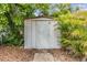 The backyard includes a storage shed surrounded by trees and foliage at 507 4Th Sw Ave, Largo, FL 33770