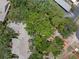 Aerial view showcases mature trees, creating a serene and private atmosphere around well-maintained residences at 5102 White Pine Ne Cir, St Petersburg, FL 33703